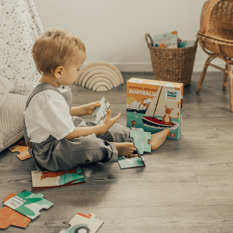 Boy playing with Mizzie Puzzle Box Set Hopping around Australia